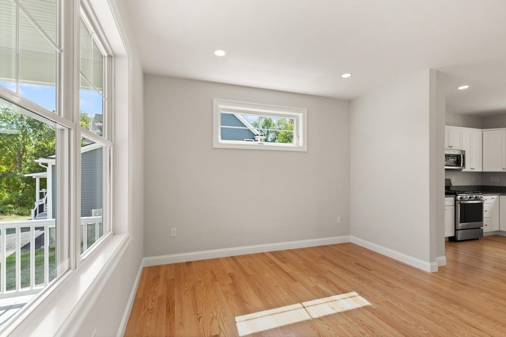 Empty room, Interior, Kitchen, Recessed Lighting, Stainless Steel Appliances, Wood Texture Flooring