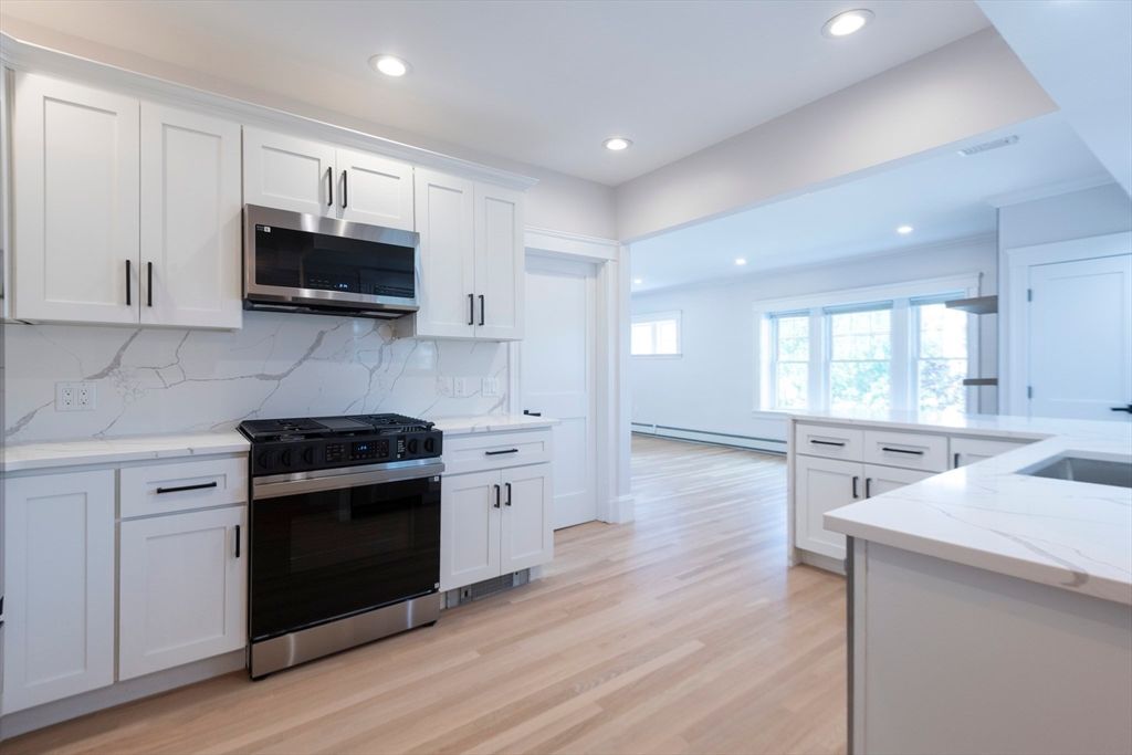 Interior, Kitchen, Marble Walls, Recessed Lighting, Stainless Steel Appliances, Wood Texture Flooring
