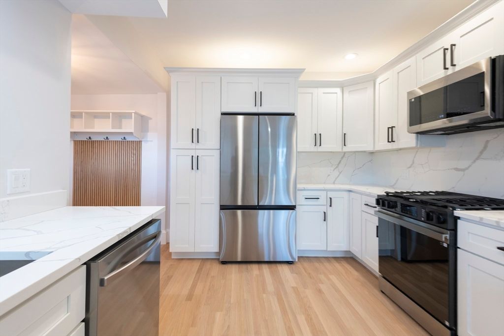 Interior, Kitchen, Marble Walls, Recessed Lighting, Stainless Steel Appliances, Wood Texture Flooring