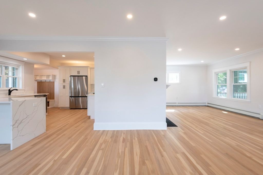 Empty room, Interior, Kitchen, Recessed Lighting, Stainless Steel Appliances, Wood Texture Flooring