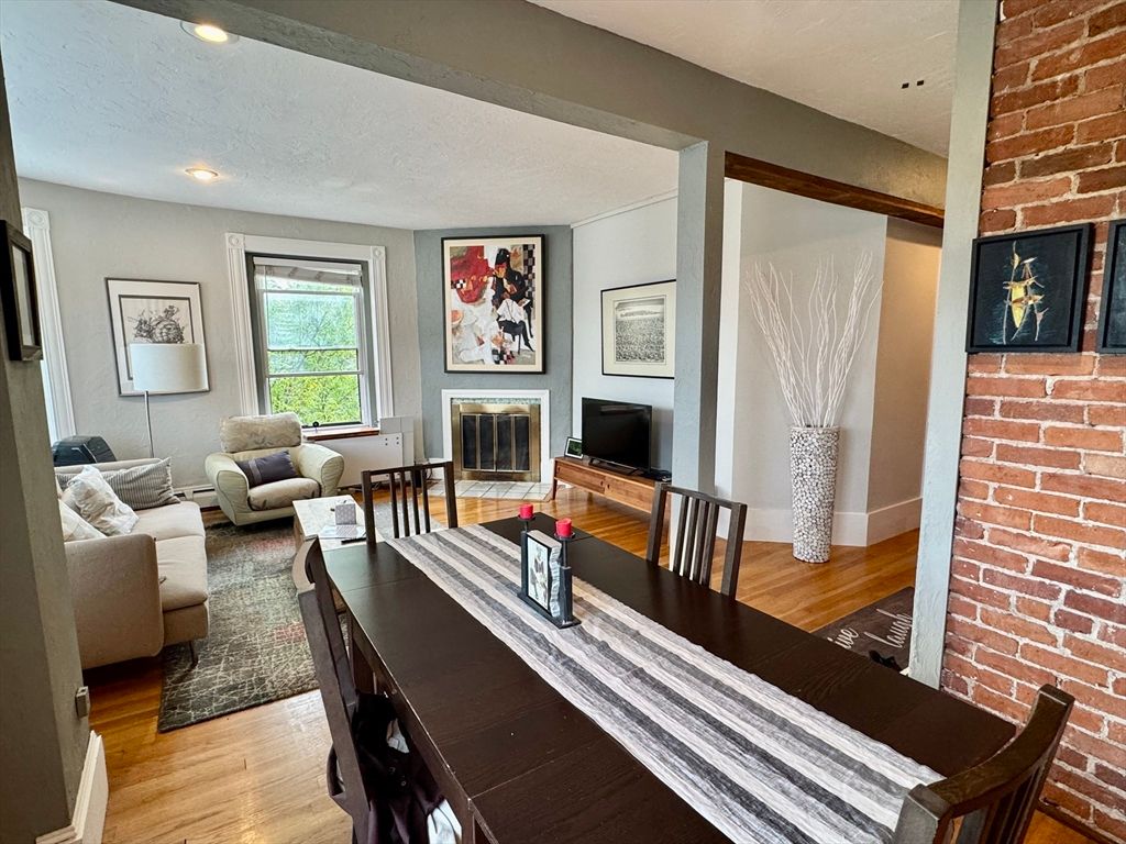 Dining room, Fireplace, Interior, Living room, Recessed Lighting, Stone Walls, Wood Texture Flooring