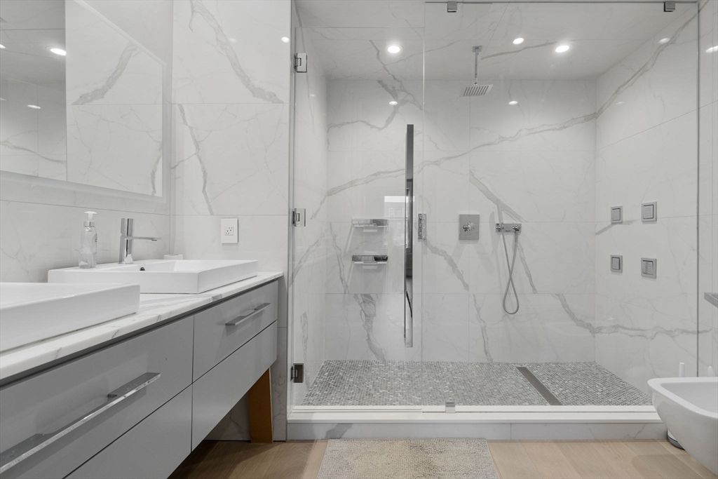 Bathroom, Dual Sink Vanities, Glass Shower, Interior, Marble Walls, Recessed Lighting, Wood Texture Flooring