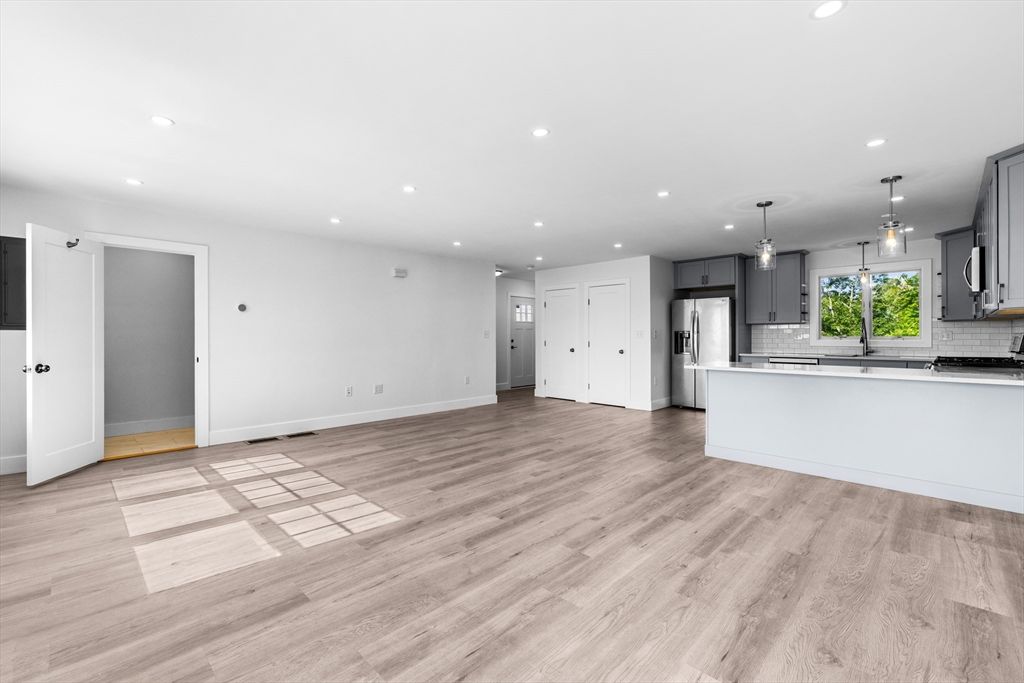 Empty room, Interior, Kitchen, Pendant Lights, Recessed Lighting, Stainless Steel Appliances, Wood Texture Flooring