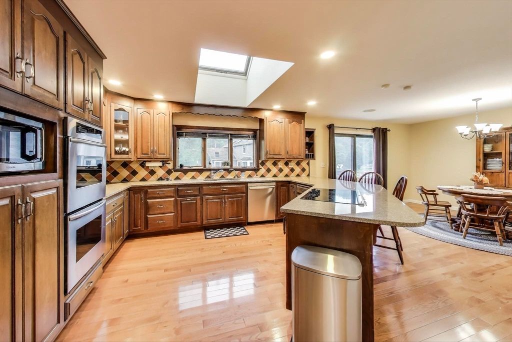 Chandelier, Dining room, Interior, Kitchen, Recessed Lighting, Stainless Steel Appliances, Wood Texture Flooring