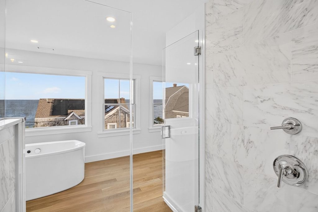 Bathroom, Free Standing Baths, Interior, Marble Walls, Recessed Lighting, Water, Wood Texture Flooring