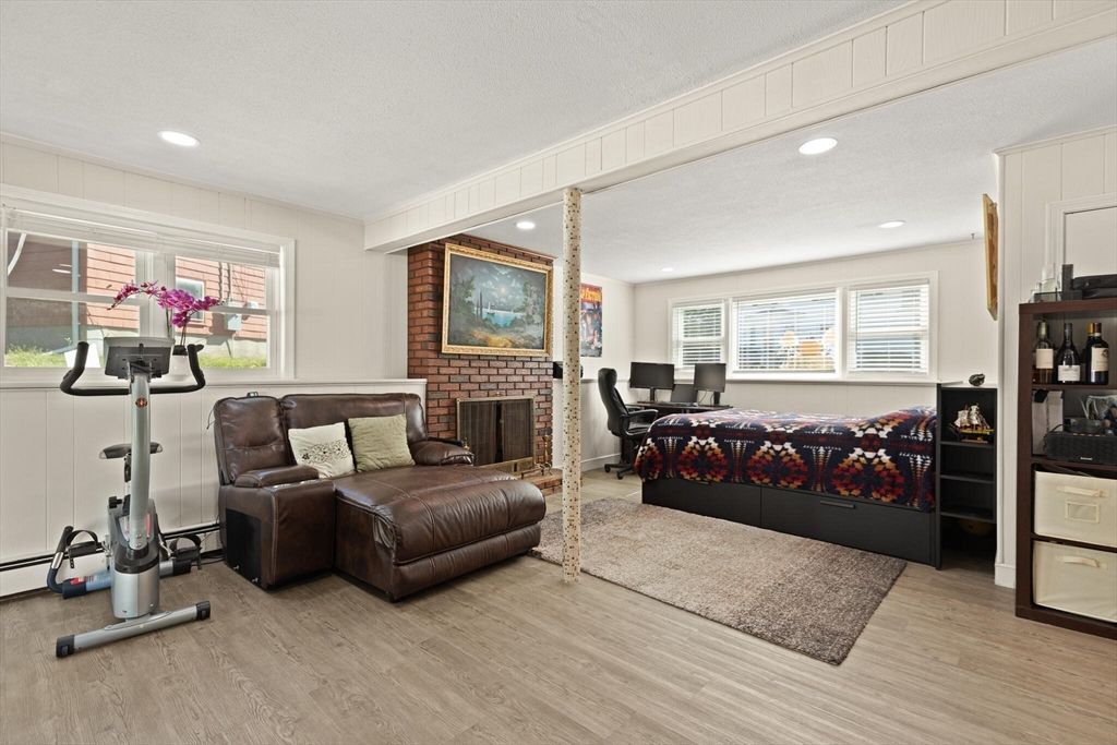 Fireplace, Fitness Equipment, Interior, Living room, Recessed Lighting, Stone Walls, Wood Texture Flooring