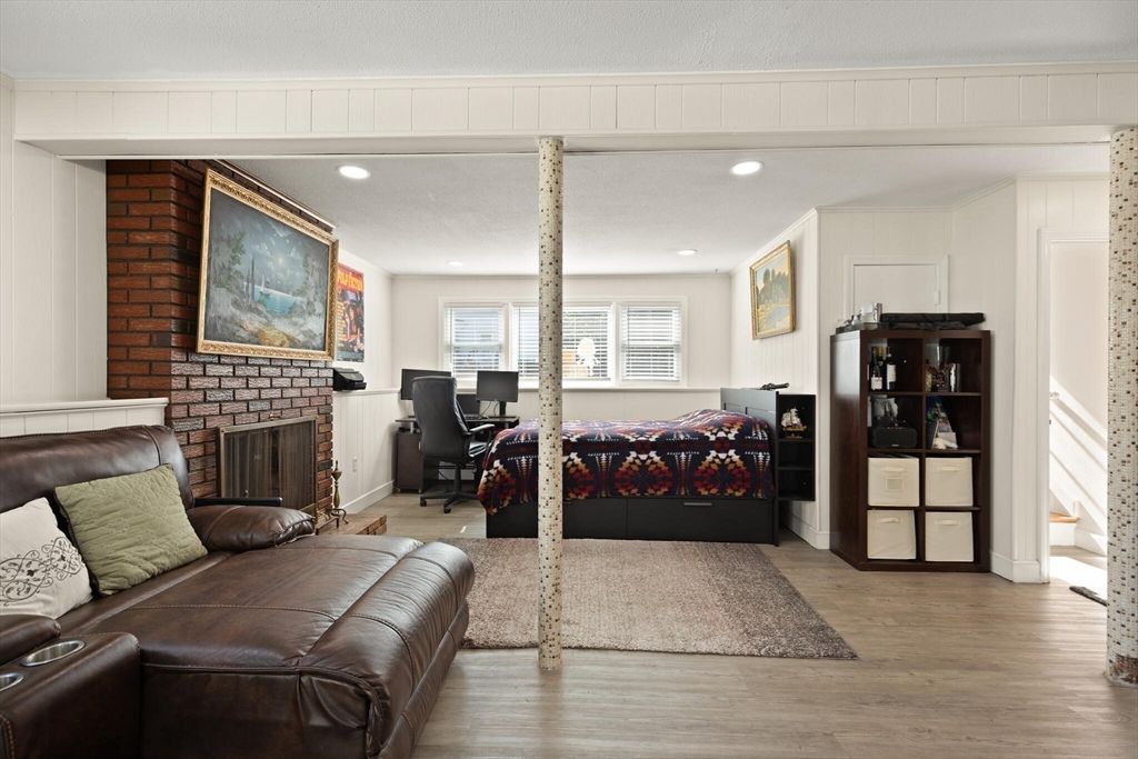 Fireplace, Interior, Living room, Recessed Lighting, Stone Walls, Wood Texture Flooring