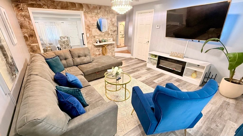 Chandelier, Fireplace, Interior, Living room, Stone Walls, Wood Texture Flooring