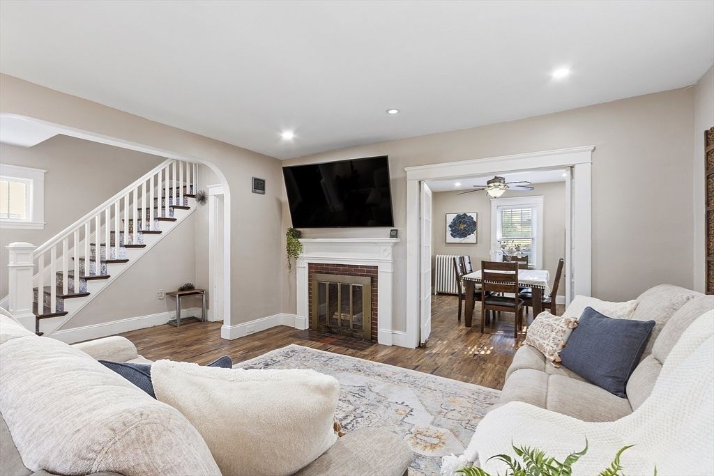 Dining room, Fireplace, Interior, Living room, Recessed Lighting, Wood Texture Flooring