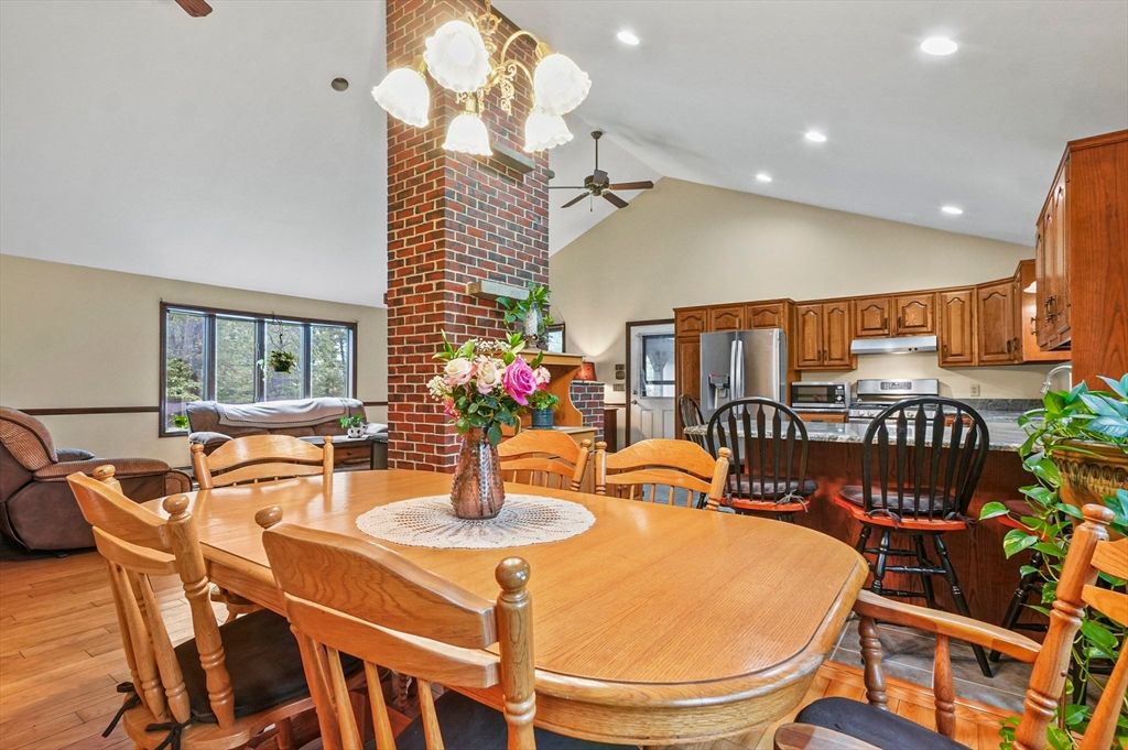 Dining room, Fireplace, Interior, Kitchen, Recessed Lighting, Stainless Steel Appliances, Stone Walls, Wood Texture Flooring