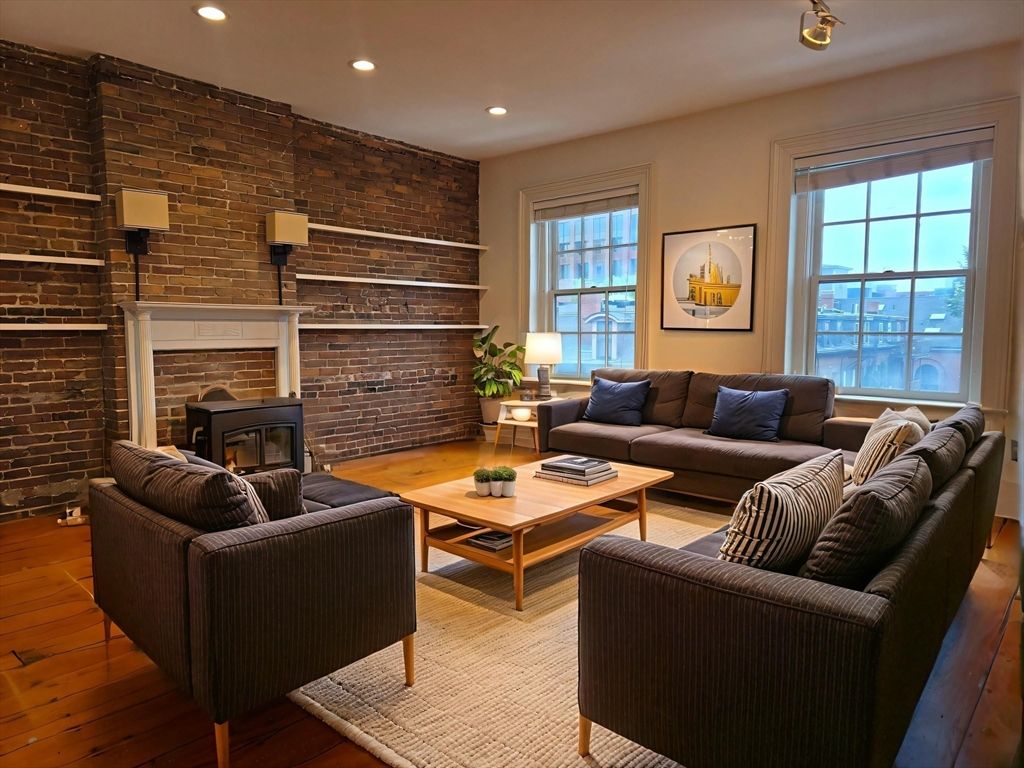 Fireplace, Interior, Living room, Recessed Lighting, Stone Walls, Wood Texture Flooring
