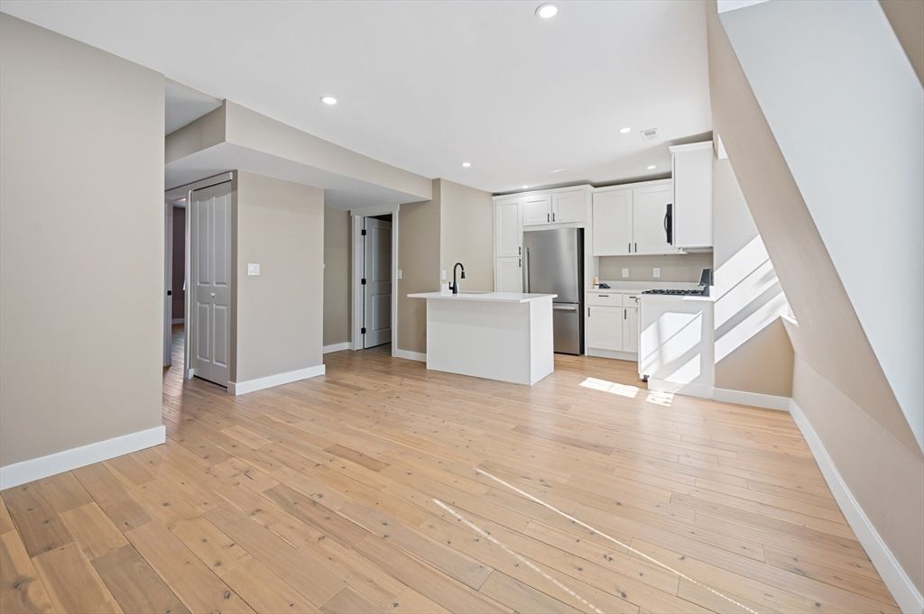 Empty room, Interior, Kitchen, Recessed Lighting, Stainless Steel Appliances, Wood Texture Flooring
