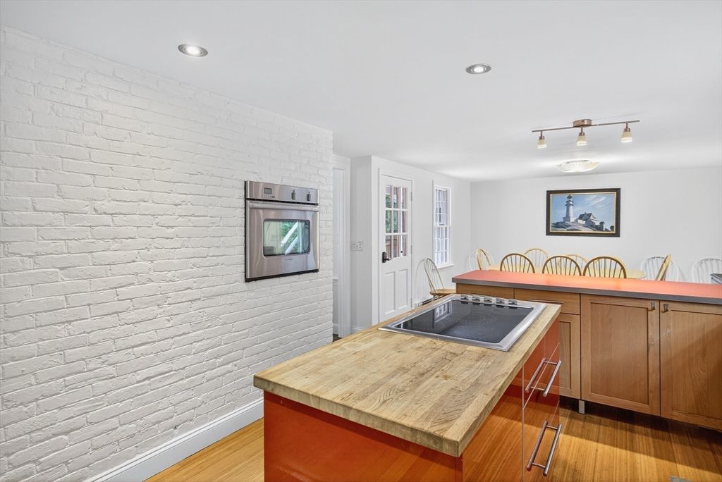 Dining room, Interior, Kitchen, Recessed Lighting, Stainless Steel Appliances, Stone Walls, Wood Texture Flooring