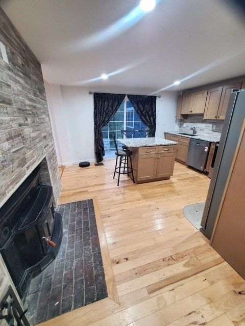 Fireplace, Interior, Kitchen, Recessed Lighting, Stone Walls, Wood Texture Flooring