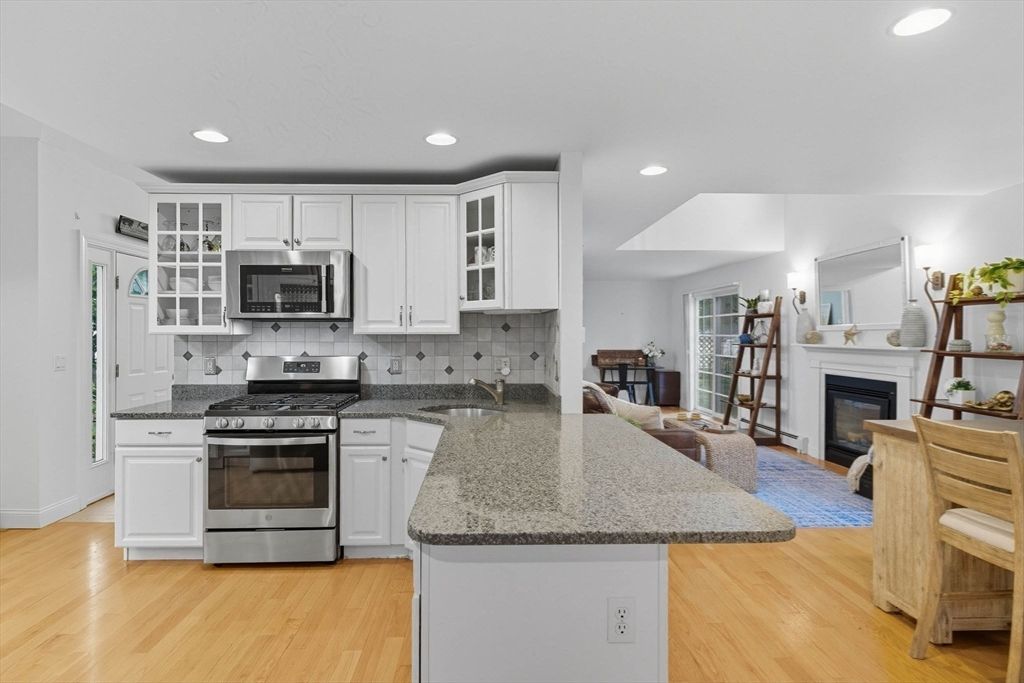 Fireplace, Interior, Kitchen, Living room, Recessed Lighting, Stainless Steel Appliances, Wood Texture Flooring
