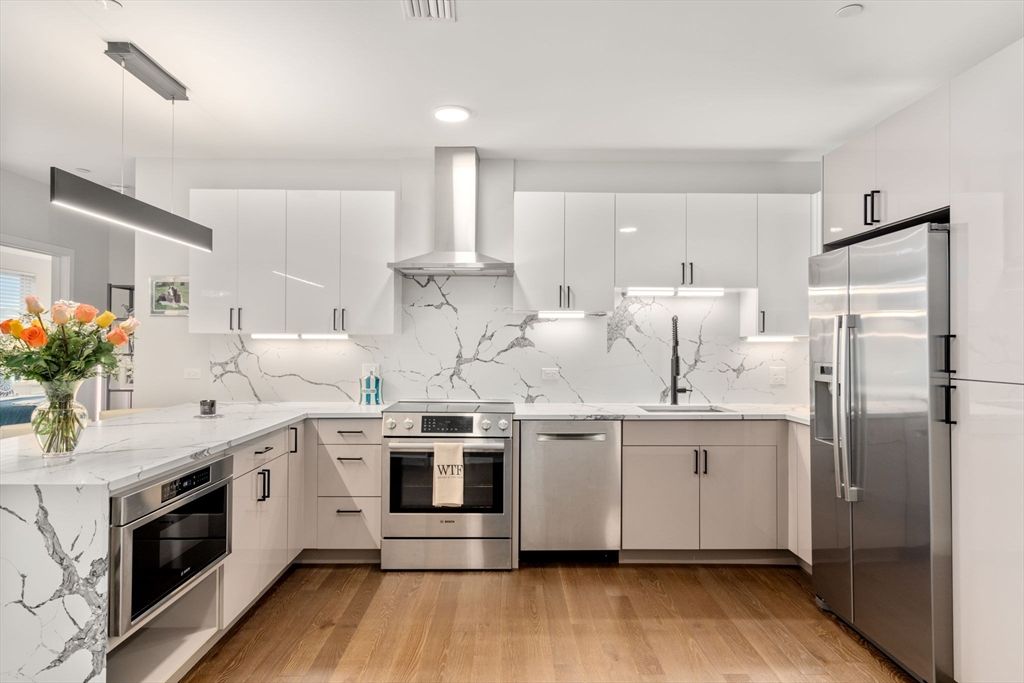 Interior, Kitchen, Marble Walls, Pendant Lights, Recessed Lighting, Stainless Steel Appliances, Wood Texture Flooring