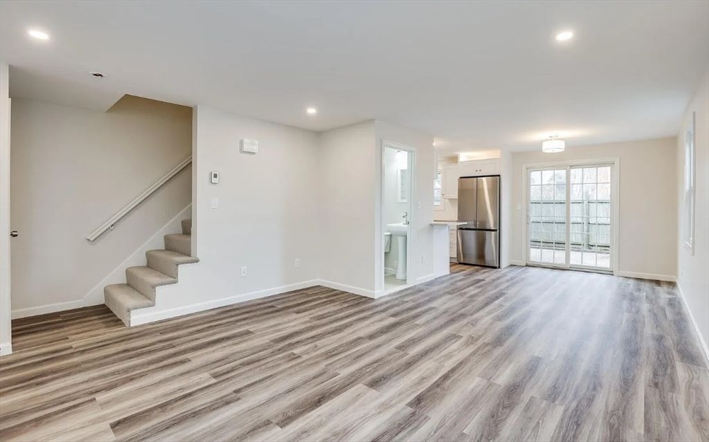 Empty room, Interior, Kitchen, Recessed Lighting, Stainless Steel Appliances, Wood Texture Flooring