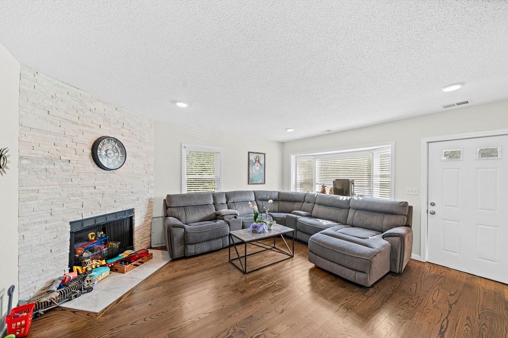 Fireplace, Interior, Living room, Recessed Lighting, Stone Walls, Wood Texture Flooring