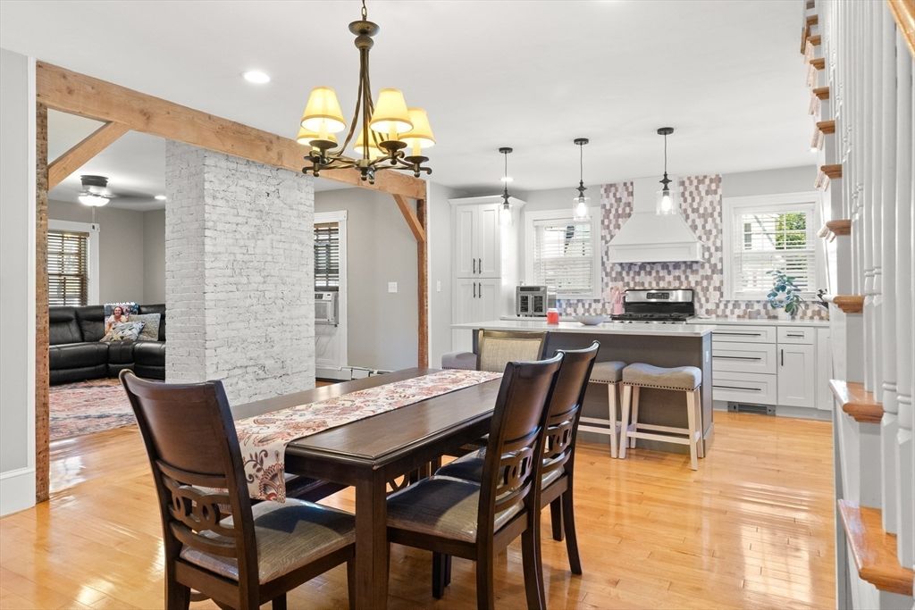 Chandelier, Dining room, Interior, Kitchen, Pendant Lights, Recessed Lighting, Stainless Steel Appliances, Stone Walls, Wood Texture Flooring