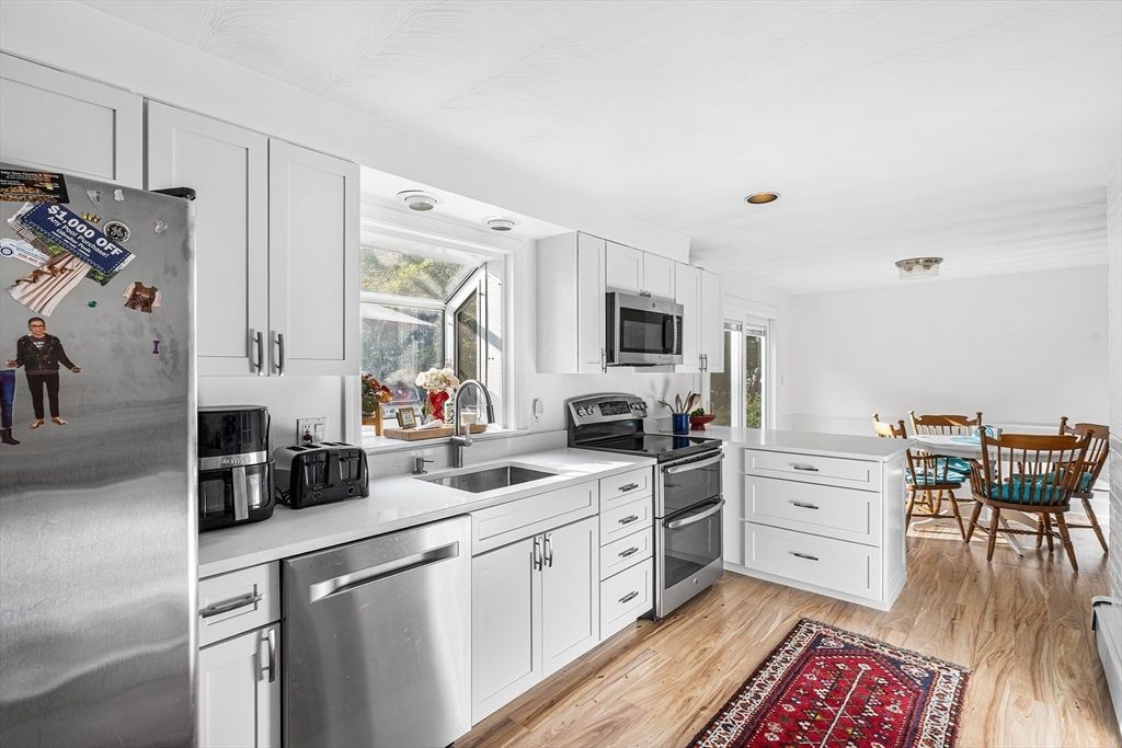 Dining room, Interior, Kitchen, Recessed Lighting, Stainless Steel Appliances, Wood Texture Flooring