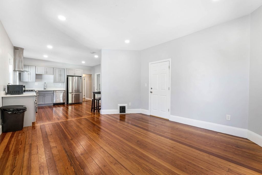 Empty room, Interior, Kitchen, Recessed Lighting, Stainless Steel Appliances, Wood Texture Flooring