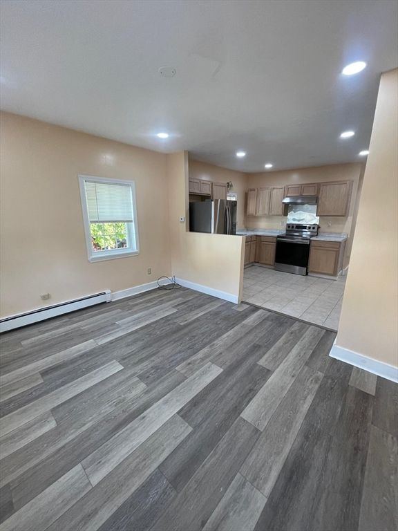 Empty room, Interior, Kitchen, Recessed Lighting, Stainless Steel Appliances, Wood Texture Flooring
