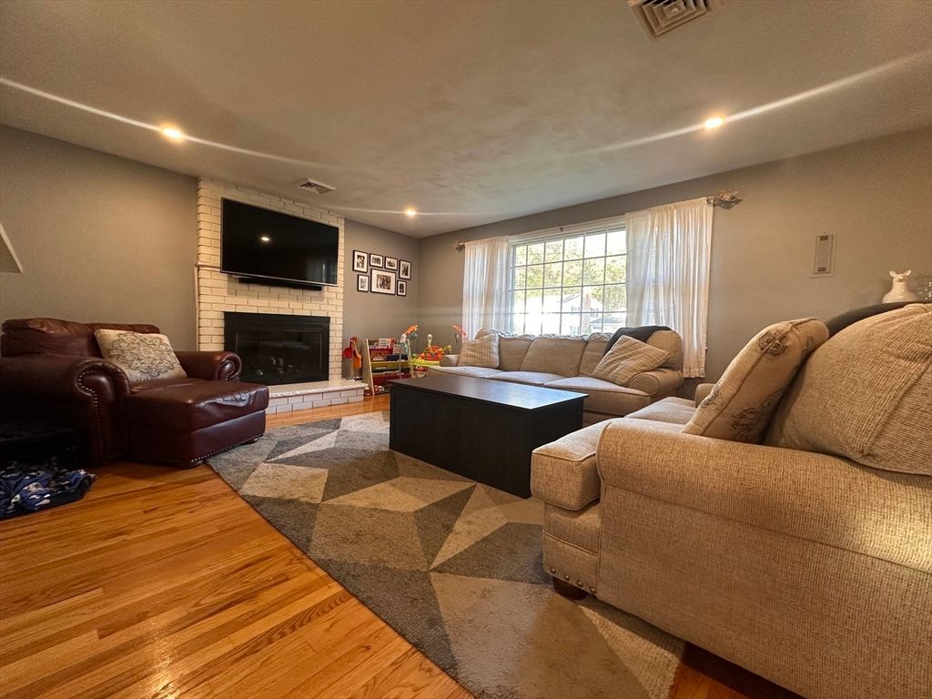 Fireplace, Interior, Living room, Recessed Lighting, Stone Walls, Wood Texture Flooring