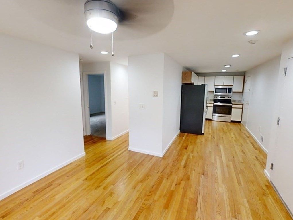 Empty room, Interior, Kitchen, Recessed Lighting, Stainless Steel Appliances, Wood Texture Flooring