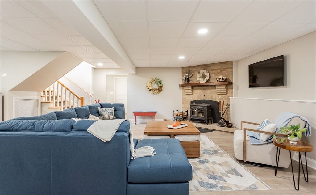 Fireplace, Interior, Living room, Recessed Lighting, Stone Walls, Wood Texture Flooring