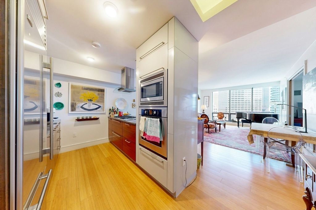 Dining room, Interior, Kitchen, Piano, Recessed Lighting, Stainless Steel Appliances, Wood Texture Flooring