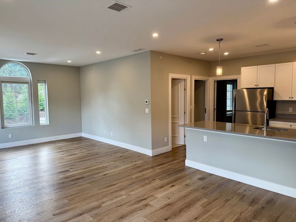 Empty room, Interior, Kitchen, Pendant Lights, Recessed Lighting, Stainless Steel Appliances, Wood Texture Flooring