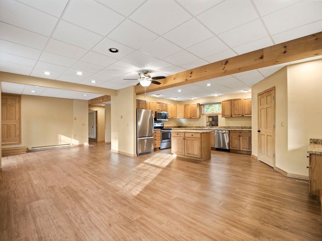 Empty room, Interior, Kitchen, Recessed Lighting, Stainless Steel Appliances, Wood Texture Flooring