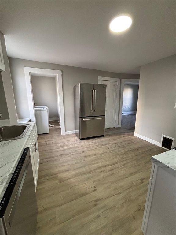 Interior, Kitchen, Recessed Lighting, Washer, Wood Texture Flooring