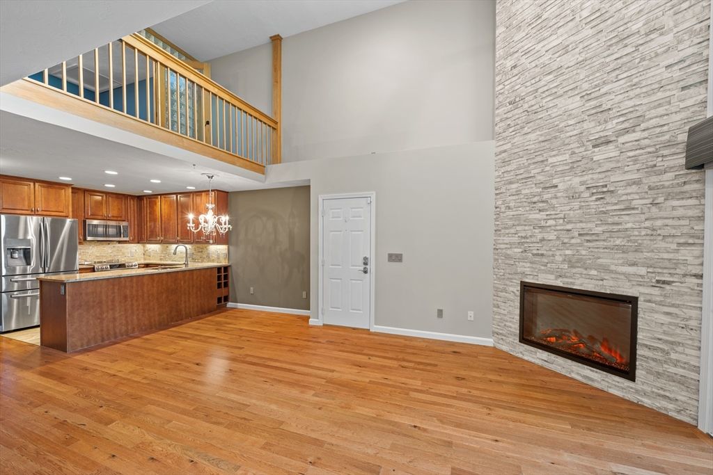 Fireplace, Interior, Kitchen, Pendant Lights, Recessed Lighting, Stainless Steel Appliances, Stone Walls, Wood Texture Flooring