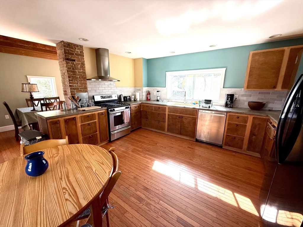 Dining room, Interior, Kitchen, Recessed Lighting, Stainless Steel Appliances, Stone Walls, Wood Texture Flooring