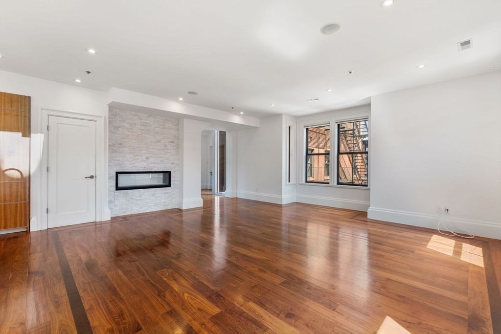 Empty room, Fireplace, Interior, Recessed Lighting, Stone Walls, Wood Texture Flooring