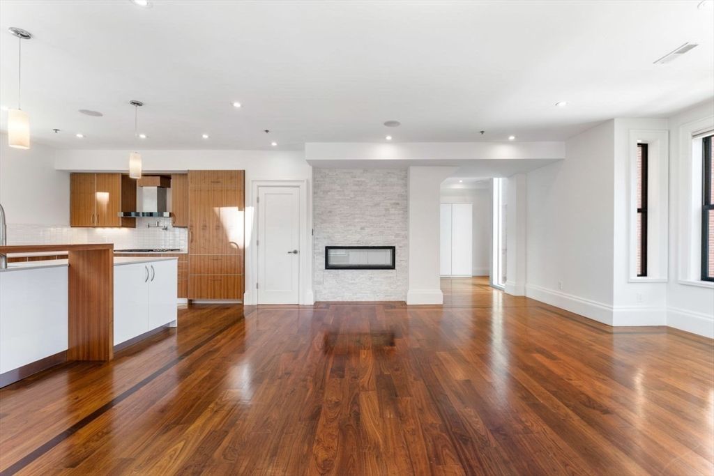 Empty room, Fireplace, Interior, Kitchen, Pendant Lights, Recessed Lighting, Stone Walls, Wood Texture Flooring