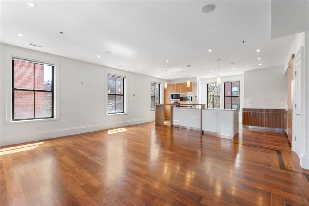 Empty room, Interior, Kitchen, Pendant Lights, Recessed Lighting, Stainless Steel Appliances, Wood Texture Flooring