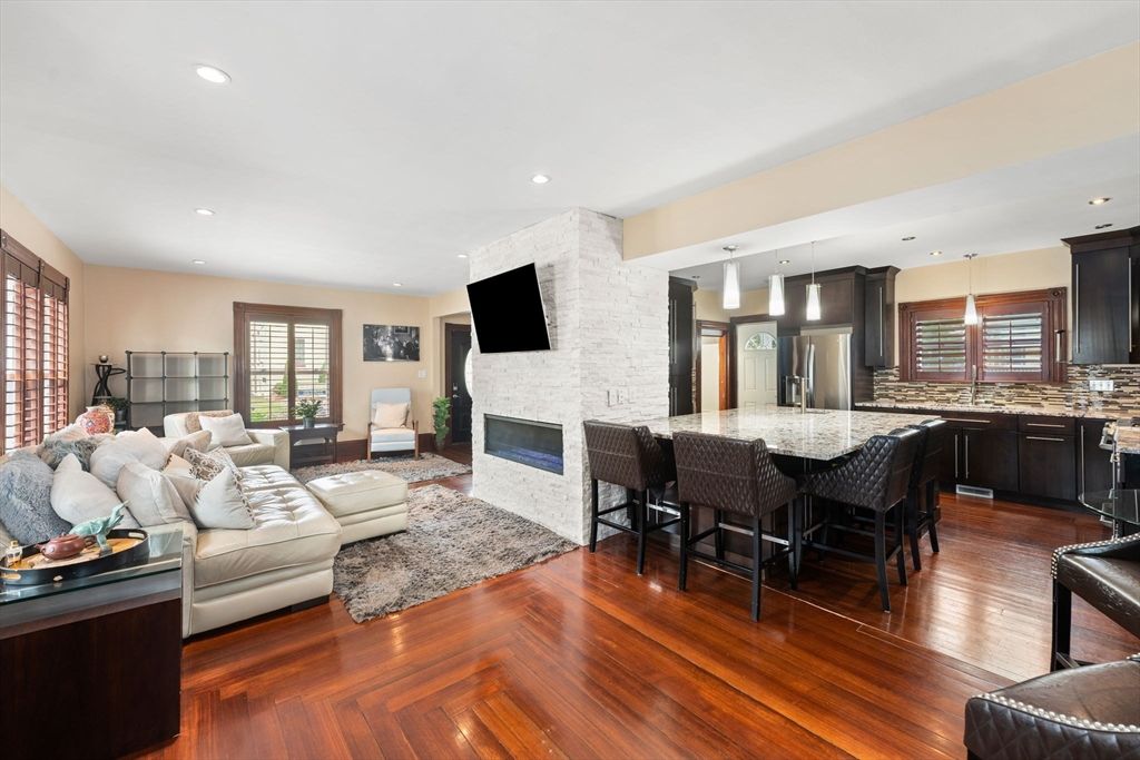 Fireplace, Interior, Kitchen, Living room, Pendant Lights, Recessed Lighting, Stainless Steel Appliances, Stone Walls, Wood Texture Flooring