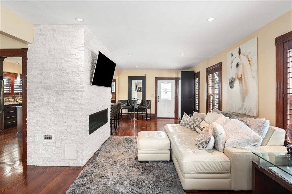 Dining room, Fireplace, Interior, Living room, Recessed Lighting, Stone Walls, Wood Texture Flooring