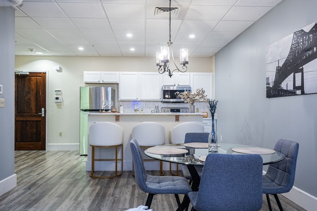 Chandelier, Dining room, Interior, Kitchen, Pendant Lights, Recessed Lighting, Stainless Steel Appliances, Wood Texture Flooring