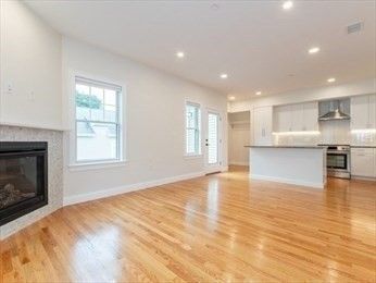 Empty room, Fireplace, Interior, Kitchen, Recessed Lighting, Stainless Steel Appliances, Wood Texture Flooring