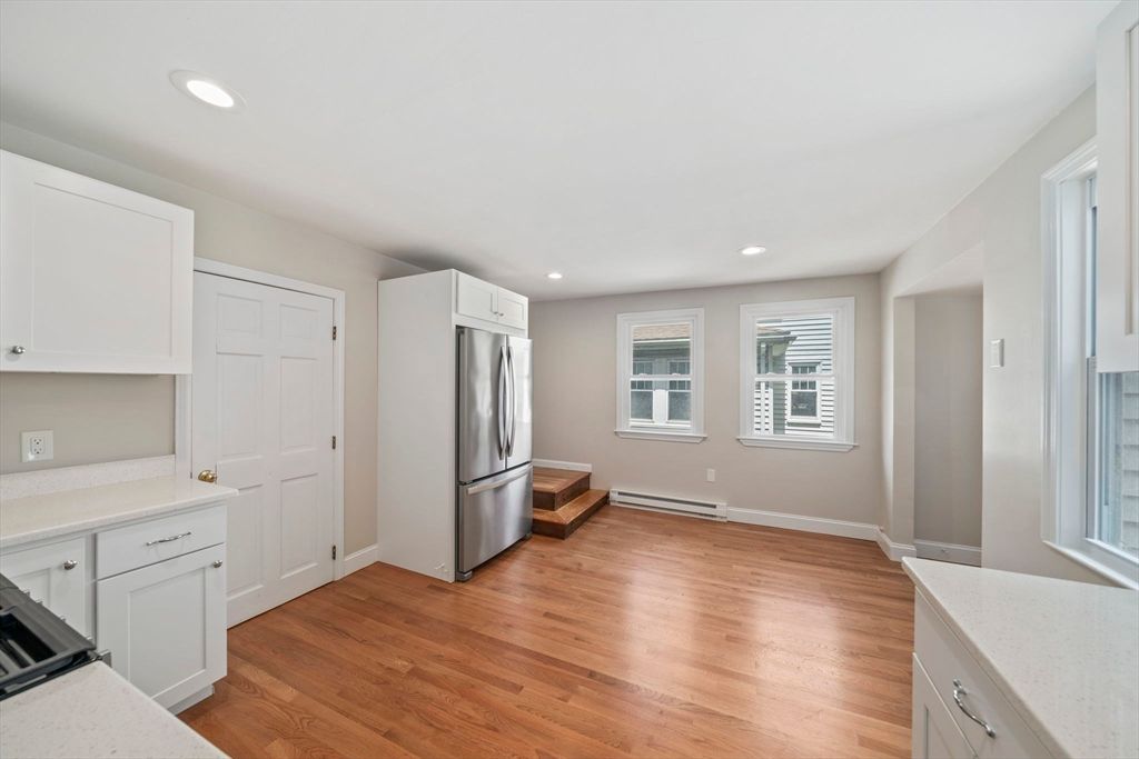 Empty room, Interior, Kitchen, Recessed Lighting, Stainless Steel Appliances, Wood Texture Flooring
