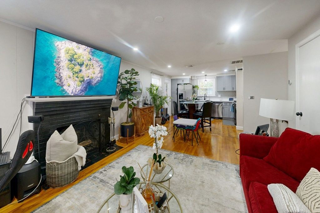 Dining room, Fireplace, Interior, Kitchen, Living room, Recessed Lighting, Stainless Steel Appliances, Wood Texture Flooring