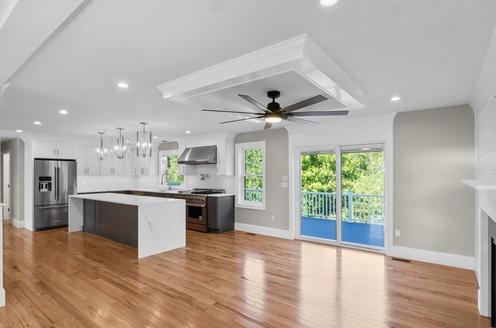 Empty room, Fireplace, Interior, Kitchen, Pendant Lights, Recessed Lighting, Stainless Steel Appliances, Wood Texture Flooring
