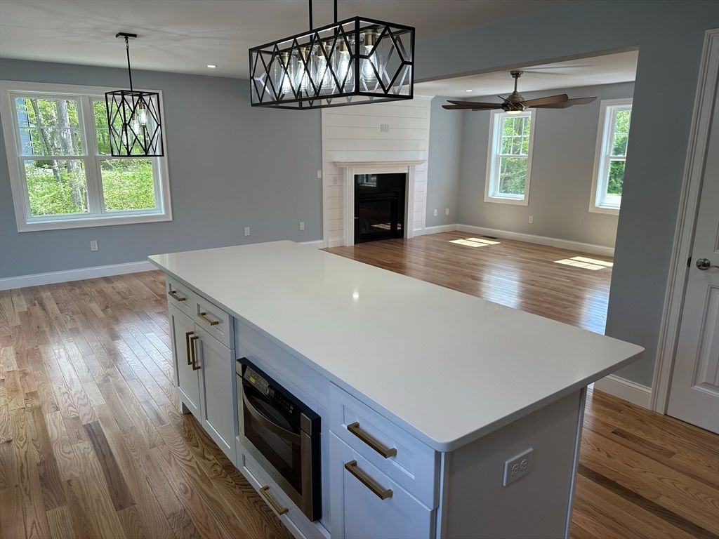 Empty room, Fireplace, Interior, Kitchen, Pendant Lights, Recessed Lighting, Wood Texture Flooring