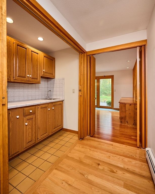 Interior, Kitchen, Recessed Lighting, Tile Countertops, Wood Texture Flooring