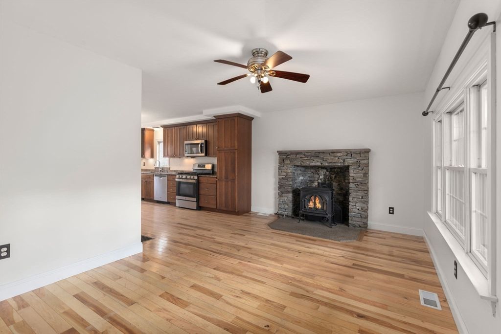Empty room, Fireplace, Interior, Kitchen, Stainless Steel Appliances, Wood Texture Flooring