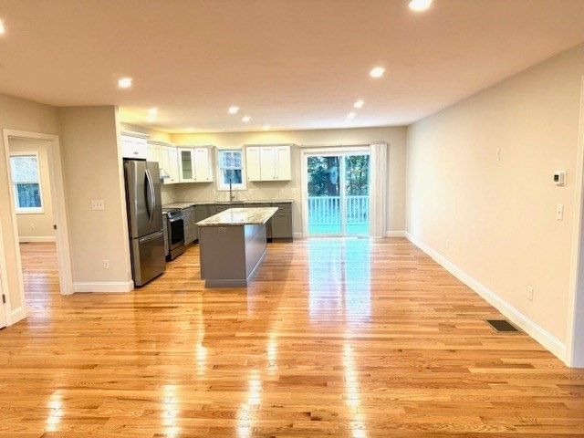 Empty room, Interior, Kitchen, Recessed Lighting, Stainless Steel Appliances, Wood Texture Flooring