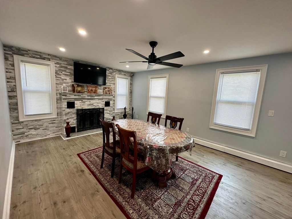 Dining room, Fireplace, Interior, Recessed Lighting, Stone Walls, Wood Texture Flooring